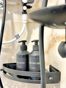 two bottles of shower gel sitting in a holder at Rufero Transit Hotel in Katunayaka