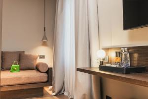 a living room with a couch and a curtain at Lenel Boutique Room - La Locanda in Brescia