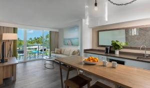 a kitchen and living room with a table with oranges on it at Amara Cay Resort in Islamorada