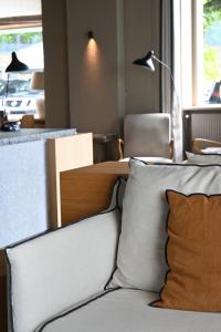 a living room with a couch and a table at Otonali hôtel by Breizh Café in Saint Malo