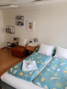 a bedroom with a bed with a blue blanket at Central tiny studio in St. Gallen
