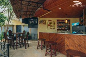 a bar with chairs and tables in a restaurant at Villa Arumeru in Arusha