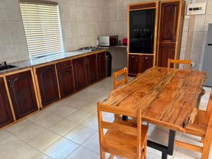 a large kitchen with a wooden table and chairs at Witgatboom Boskamp in Naboomspruit