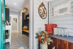a hallway with a blue and white wall with a red pillow at Rosewood Guesthouse in Margaret River Town +8 photos