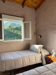 a bedroom with a bed and a window with a view at El Refugio de Juncalillo in Gáldar