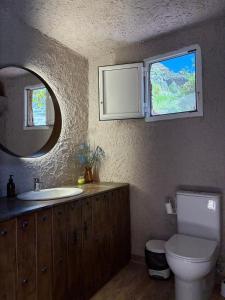 a bathroom with a sink and a toilet and a mirror at El Refugio de Juncalillo in Gáldar +27 photos