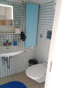 a bathroom with a toilet and a sink at Central tiny studio in St. Gallen +12 photos