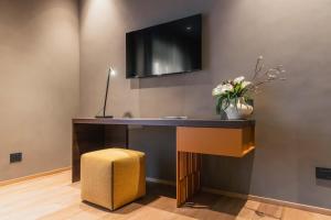 a desk with a tv on a wall at Lenel Boutique Room - La Locanda in Brescia +31 photos