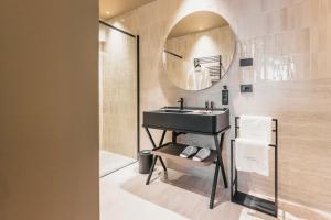 a bathroom with a black sink and a mirror at Lenel Boutique Room - La Foresteria in Brescia