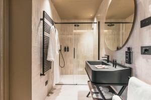 a bathroom with a black sink and a shower at Lenel Boutique Room - La Foresteria in Brescia +35 photos