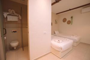 a bathroom with two beds and a toilet at Voyage On The Spot in Cairo