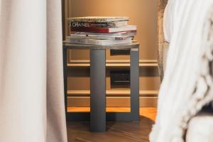 a pile of books on a table in a room at Lenel Boutique Room - La Foresteria in Brescia