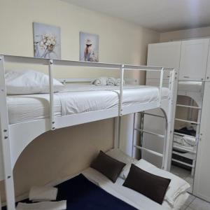 two bunk beds in a small room with a bed at Anna in Cavallino-Treporti +11 photos