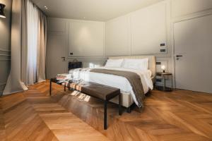 a bedroom with a large bed and a table at Lenel Boutique Room - La Foresteria in Brescia