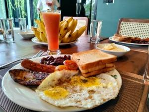 a plate of breakfast food with eggs sausage and toast at Ranmin Lake Weerawila in Weerawila