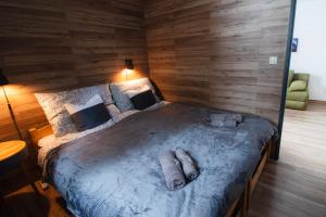 a bedroom with a large bed with wooden walls at Apartmán Tady 67 in Dolní Moravice