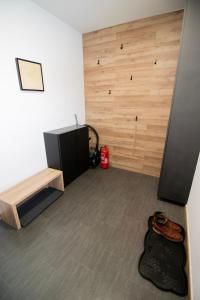 a room with a wooden wall with a table and a desk at Apartmán Tady 67 in Dolní Moravice