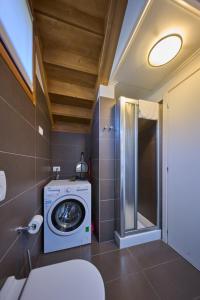 a bathroom with a washing machine and a shower at Paradiso del lago in Bellano +96 photos