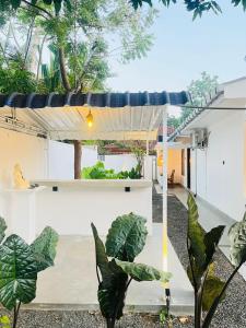 an outdoor patio with a pergola and plants at La Manga Mirissa in Mirissa