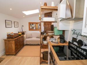 a room with a kitchen and a living room at Tucked Away in Evesham