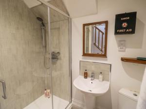 a bathroom with a shower and a sink at Tucked Away in Evesham +17 photos