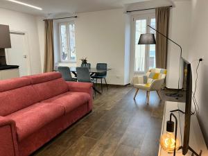 a living room with a red couch and a table at Garibaldi 105 in Castrovillari