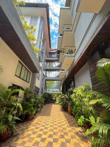 a hallway of an apartment building with plants at Nitya Resort, Calangute in Calangute
