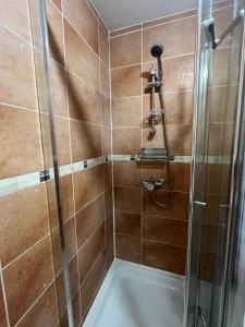 a bathroom with a shower with a tub at Private Studio by Wembley in Preston