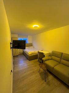 a living room with a couch and a bed at Private Studio by Wembley in Preston
