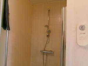 a shower in a bathroom with a glass door at b&b Kraaiberg in Ploegsteert