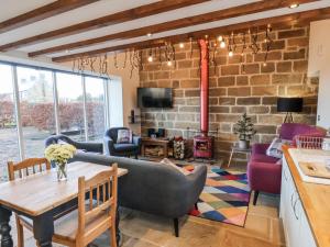 a living room with a brick wall at Chestnut Barn in Whitby