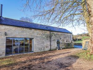 a stone building with a large window on the side at Chestnut Barn in Whitby