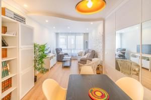 a room with a table and chairs and a living room at Espacioso y cómodo apartamento en Pamplona in Barañáin