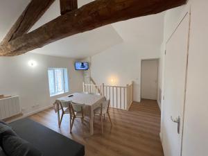 a kitchen and dining room with a table and chairs at Signature Apartment in Pélussin