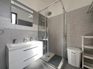 a bathroom with a sink and a glass shower at Albert's apartments in Larnaca +43 photos
