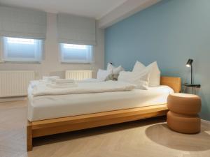 a bedroom with a large bed with white pillows at OSTKÜSTE - Villa Steigel Design Apartments in Ahlbeck
