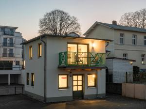 a house with a balcony on top of it at OSTKÜSTE - Villa Steigel Design Apartments in Ahlbeck
