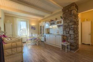 a kitchen and living room with a stone pillar at Viterbo Antica Casa Vacanze in Viterbo