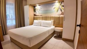 a hotel room with a bed and a window at Asya Blue Apartments in Marmaris +9 photos