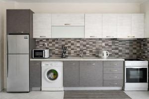 a kitchen with a washing machine and a dishwasher at Rona Vista Suites amazing seaview 3 in Polychrono