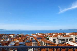 a view of a city with houses and the ocean at Rona Vista Suites amazing seaview 3 in Polychrono