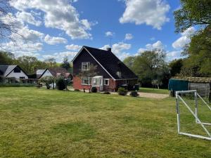 a house with a soccer ball in a field at Roslyn in Romsey