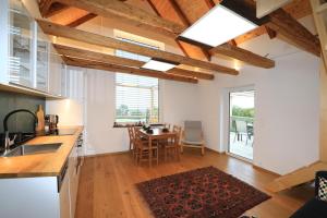 a kitchen and living room with a table and chairs at Kellerstöckl Pachler in Bad Gleichenberg +24 photos