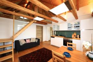 a kitchen and living room with a table and a couch at Kellerstöckl Pachler in Bad Gleichenberg