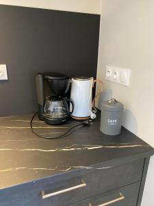 a counter with two coffee makers on top of it at Sous l'Alpette en Chartreuse in Saint-Pierre-dʼEntremont
