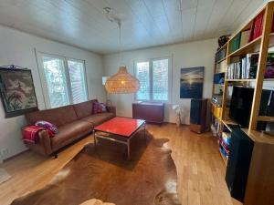 a living room with a couch and a table at Villa Santala in Naantali