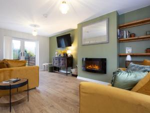 a living room with a couch and a fireplace at Thieveley Pike View in Burnley