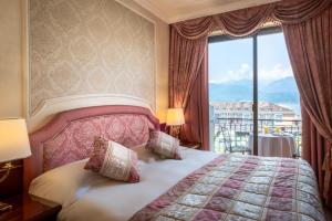 a bedroom with a bed and a large window at Grand Hotel Dino in Baveno +222 photos