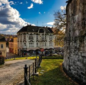 a large white building on a street with a fence at Zamkowa Apart in Cieszyn +5 photos