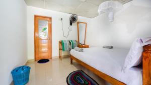 a bedroom with a bed and a mirror and a door at Sigiri Binara Villa in Sigiriya